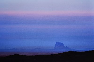 Scenic view of silhouette land against sky at sunset