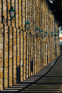 View of street light on footpath by building