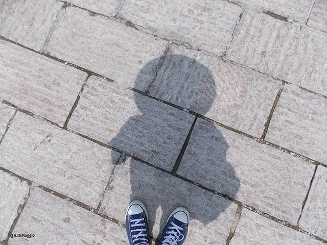 low section, shoe, person, personal perspective, high angle view, footwear, human foot, standing, lifestyles, paving stone, cobblestone, tiled floor, unrecognizable person, men, street, footpath, leisure activity