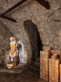 Statue against brick wall in building