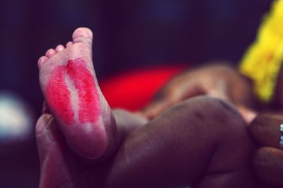 Close-up of lipstick kiss on baby foot