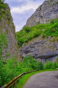 Road amidst rocks against sky