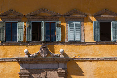 Low angle view of birds against building