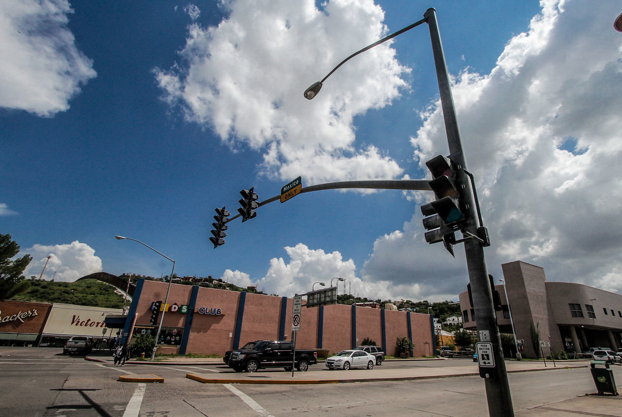 sky, cloud, architecture, city, built structure, building exterior, nature, street, transportation, street light, mode of transportation, day, road, vehicle, outdoors, motor vehicle, building, no people, urban area, car, lighting, tree