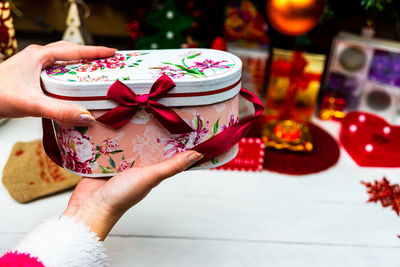 Close-up of woman holding christmas decoration in box