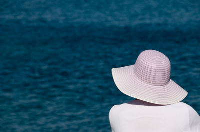 Rear view of woman against swimming pool