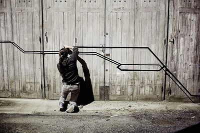 Full length of woman standing by railing