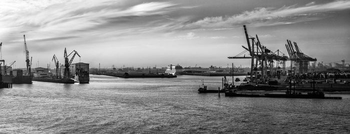 Commercial dock against cloudy sky