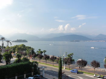 Scenic view of sea by city against sky