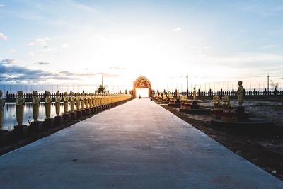 Footpath leading towards building against sky