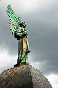 Low angle view of statue against sky