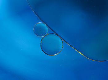 Close-up of bubbles against blue sky