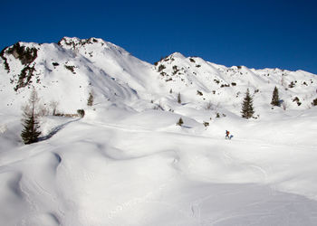 Scenic view of snow covered mountain against sky