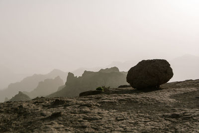 Rocks on mountain against clear sky