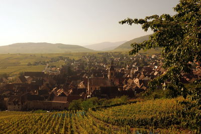 Aerial view of houses in village against mountains