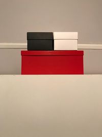 Close-up of red box against white wall