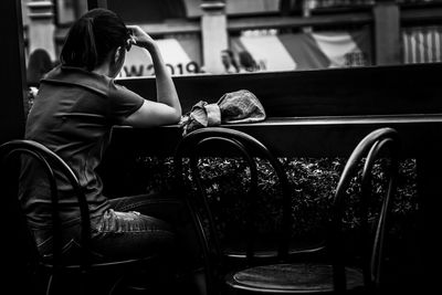 Side view of woman sitting at cafe