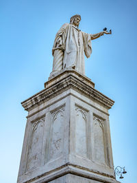 Low angle view of statue against sky