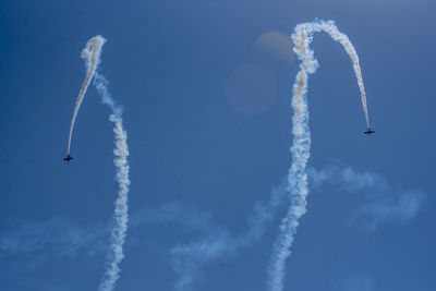Low angle view of airshow against sky
