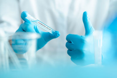 Close-up of hand holding bottle