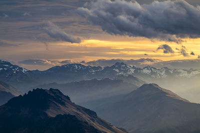 Scenic view of snowcapped mountains against sky during sunset