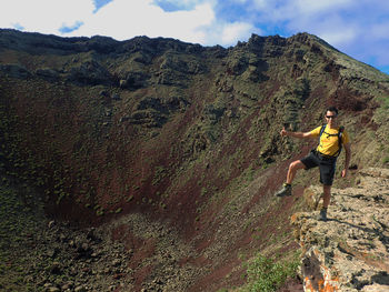 Full length of man standing at volcanic crater
