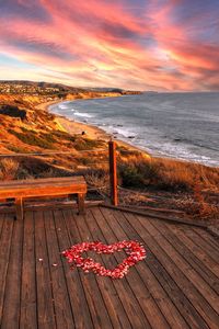 A heart on a boardwalk and bench in crystal cove state park on the edge of laguna beach 