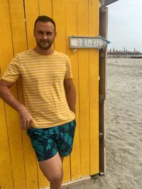 Portrait of young man standing on beach
