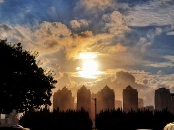 Low angle view of silhouette buildings against sky during sunset