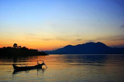 Scenic view of lake at sunset