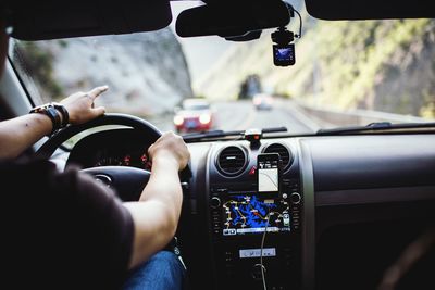 Close-up of hands of a man driving