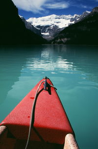 Scenic view of lake by mountain against sky