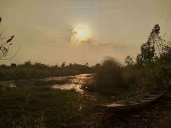 Scenic view of field against sky at sunset
