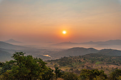 Scenic view of mountains against sky during sunset