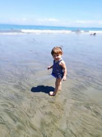 Tilt-shift portrait of cute girl on shore at beach