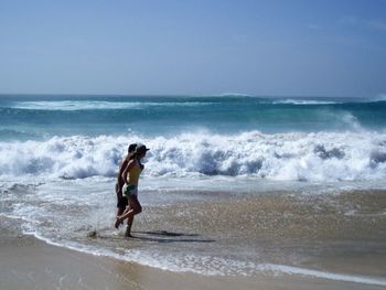 Scenic view of sea with waves in background