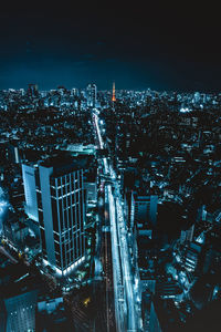 High angle view of illuminated buildings in city at night