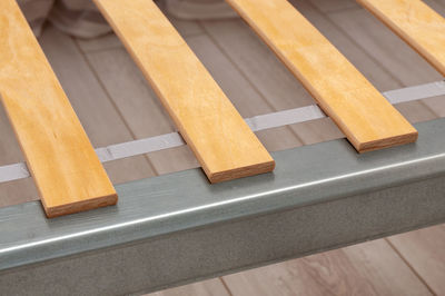 High angle view of piano keys on wooden floor