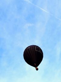 Low angle view of balloons flying against blue sky