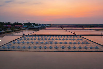 High angle view of roof and building against sky during sunset