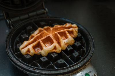 Croffle is a combination of croissant and waffle. this croffle served on a white plate