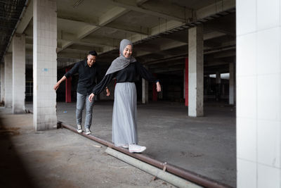 Full length of young man standing in building