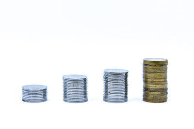 Close-up of coins over white background