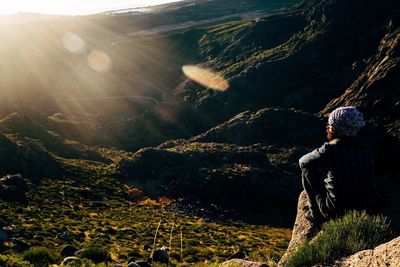 Man on mountain road against sky