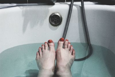 Low section of woman legs in water