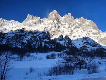 Scenic view of snow covered mountains against sky
