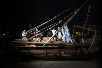 People on boat against clear sky at night