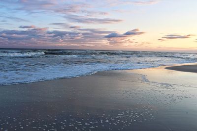 Scenic view of beach against sky during sunset