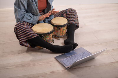 High angle view of woman playing drum