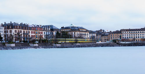 Houses in city against sky during winter